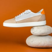 left white and brown sneaker placed on top of two stones