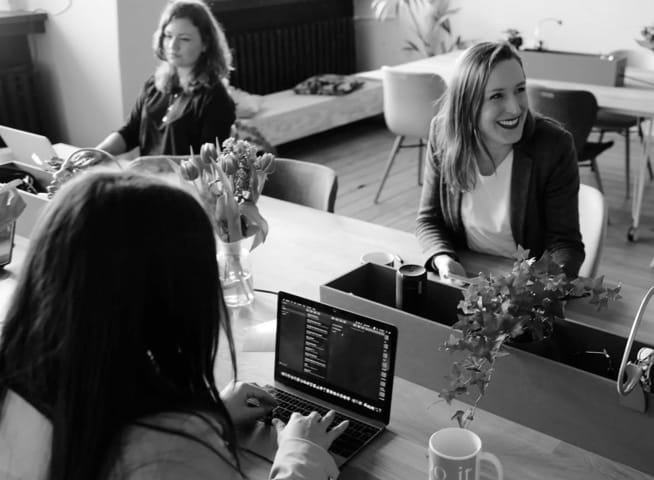 three caucasian women working in an office